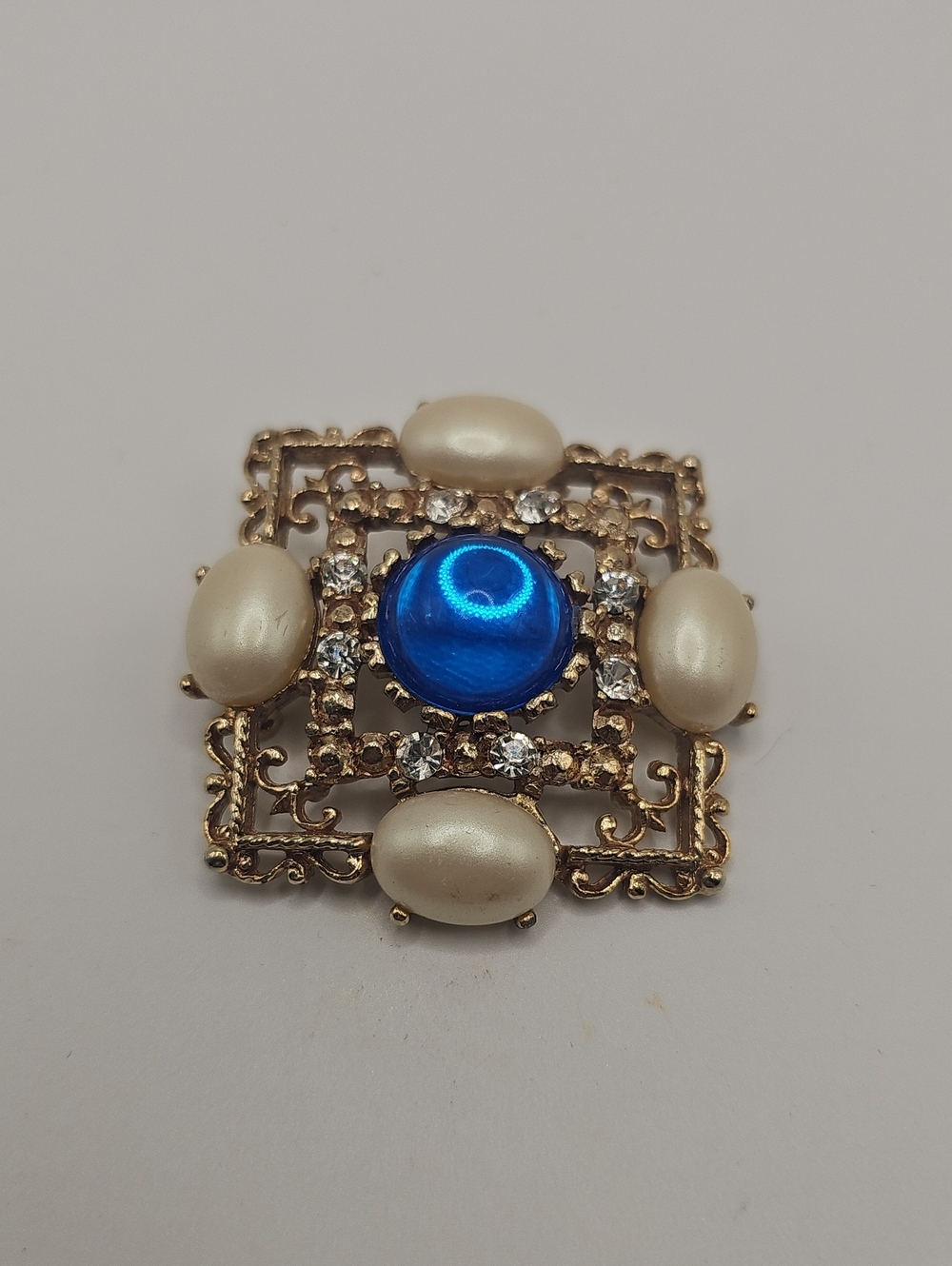 Gold-Tone Brooch with Blue Cabochon and Pearl Accents. Not Siighned